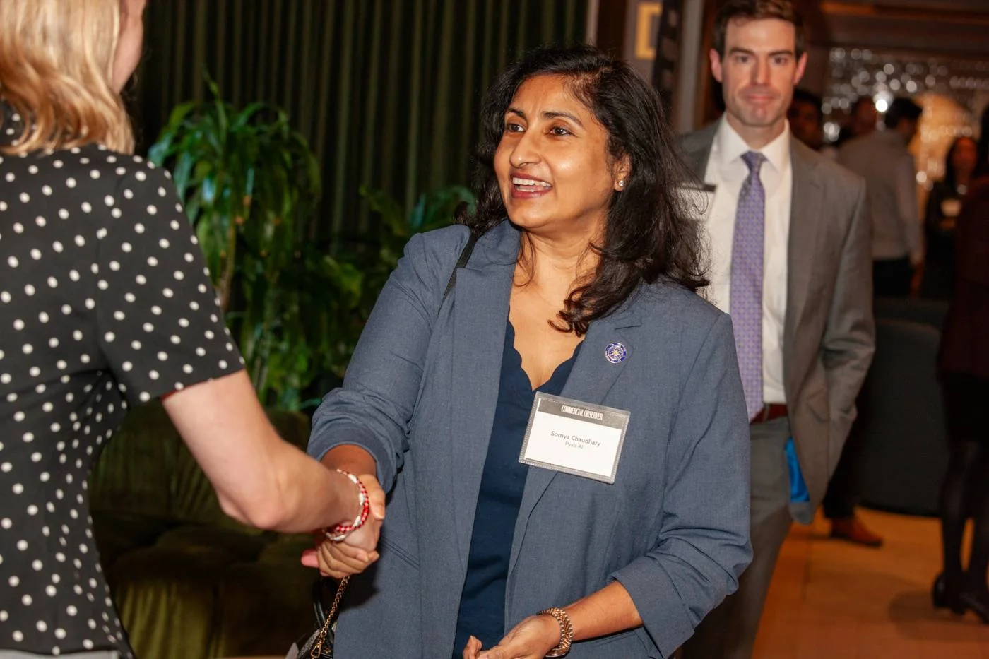 Somya Chaudhary greeting a guest at the reception