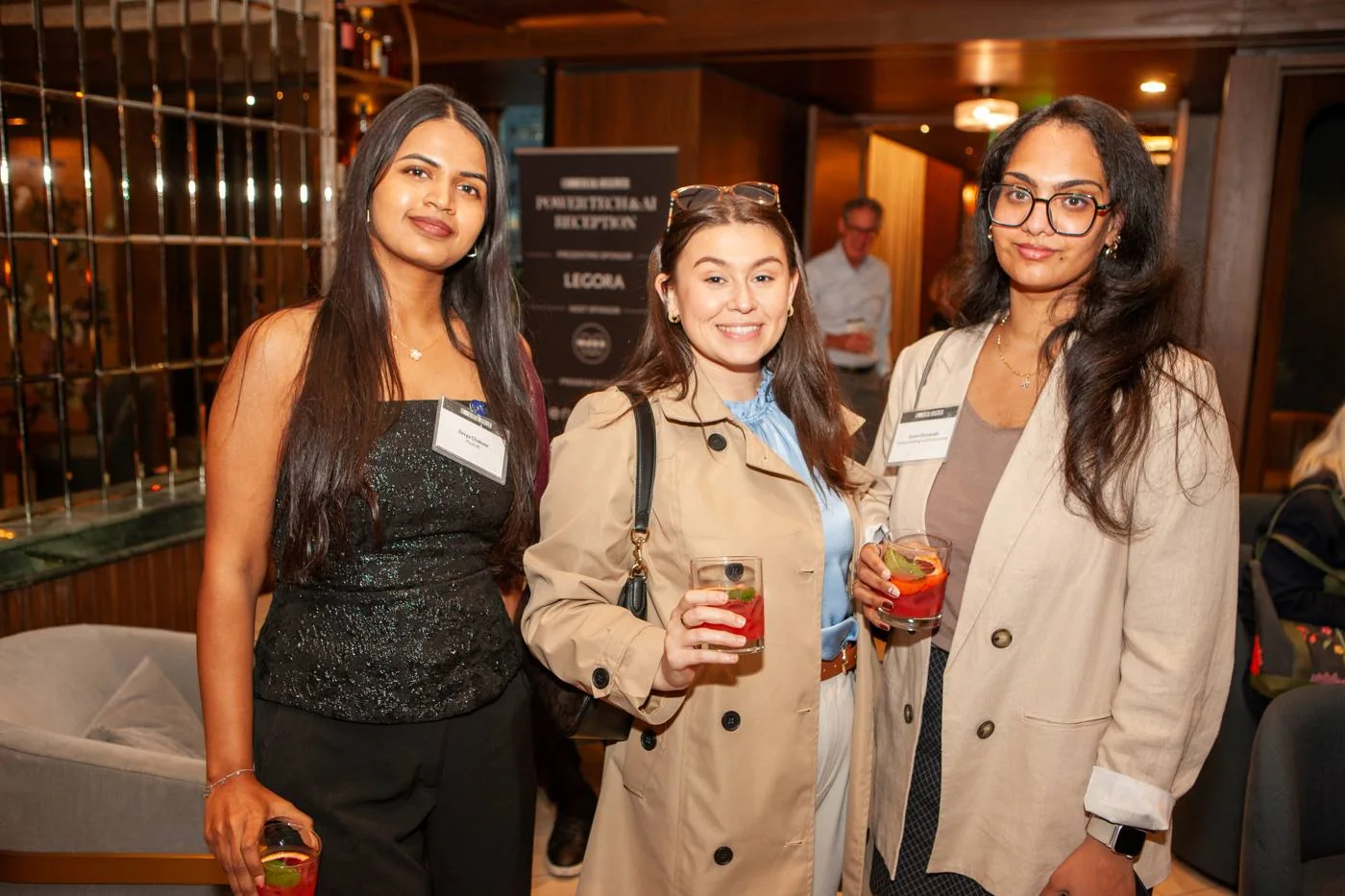 Pyxis AI with guests in front of the reception banner